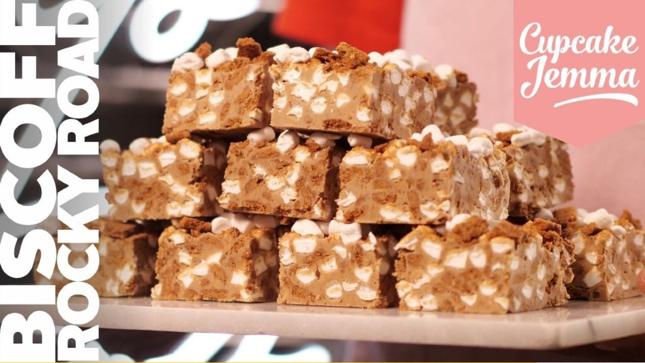 Stacked squares of Biscoff Rocky Road with marshmallows and cookie pieces in a recipe by Cupcake Jemma