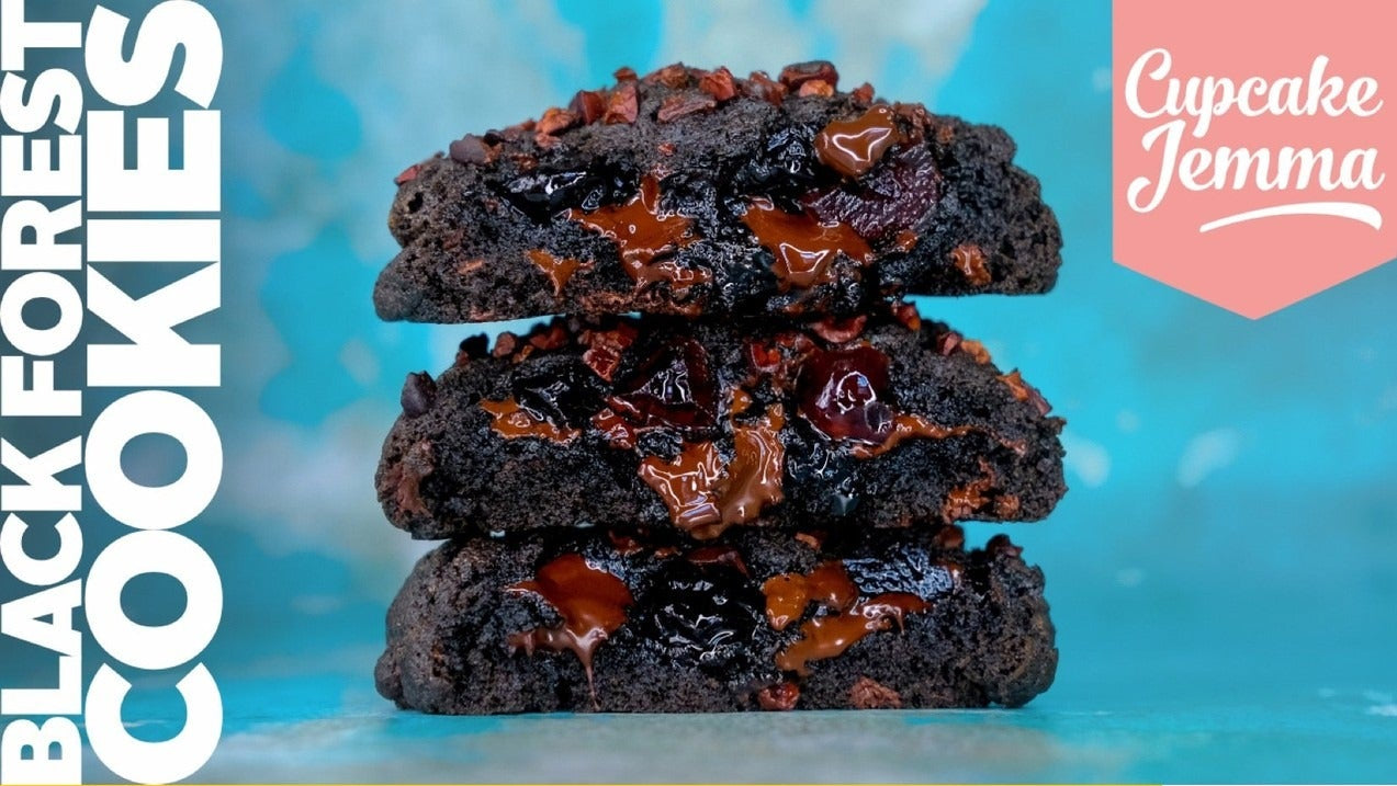 Stack of gooey Black Forest New York Cookies with melted chocolate and cherries by Cupcake Jemma recipe ingredients list below