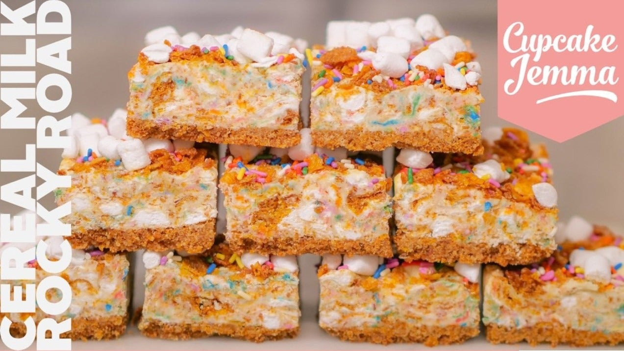 Stack of colorful Cereal Milk Rocky Road dessert squares with marshmallows and sprinkles by Cupcake Jemma