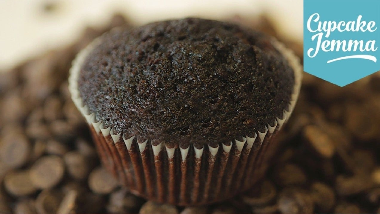 Close-up of a rich chocolate cupcake with Cupcake Jemma logo and ingredients list for Chocolate Cupcakes downloadable recipe