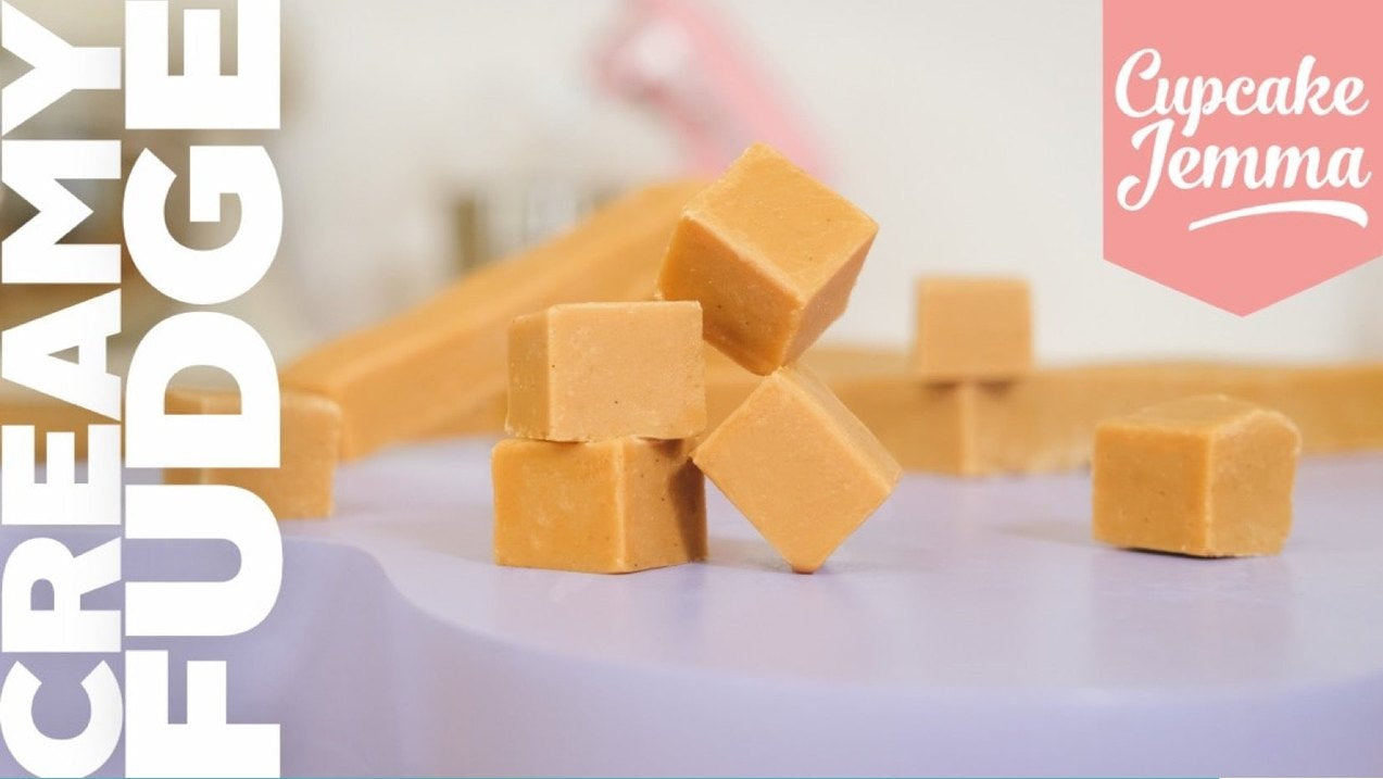 Stacked creamy fudge cubes on a plate with the Creamy Fudge downloadable recipe ingredients and Cupcake Jemma branding