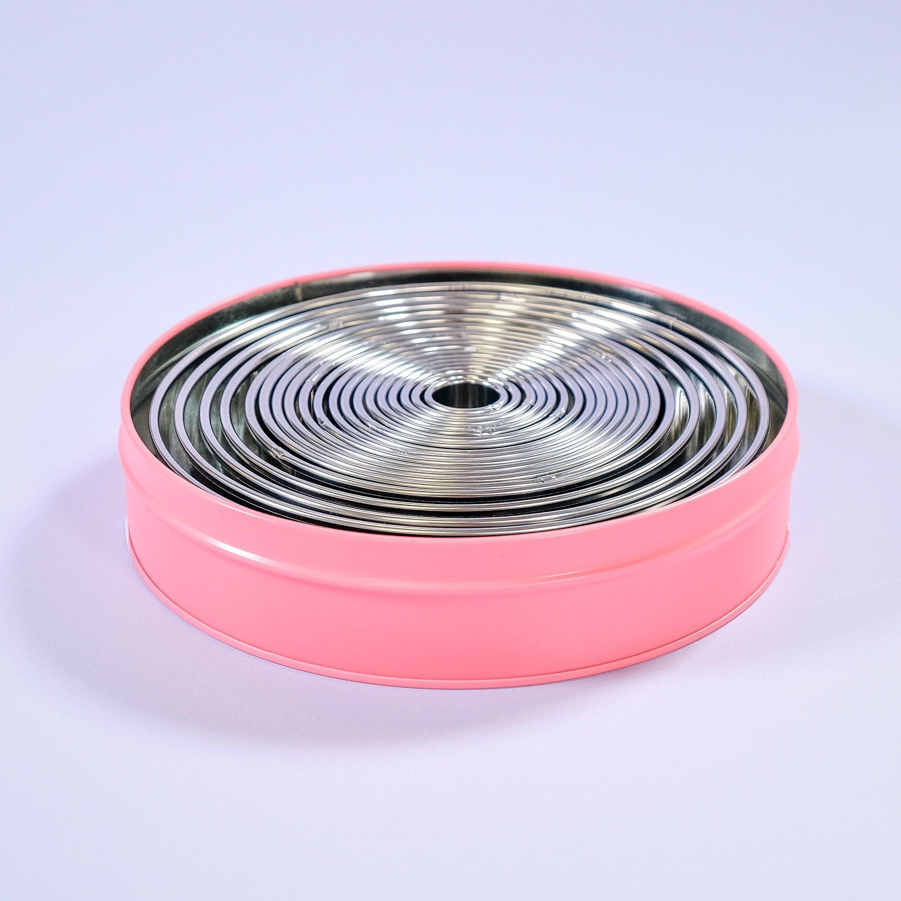 Cake Ring and Cookie Cutter Set with 19 stainless steel circle cutters stored in a round pink metal tin for baking tasks