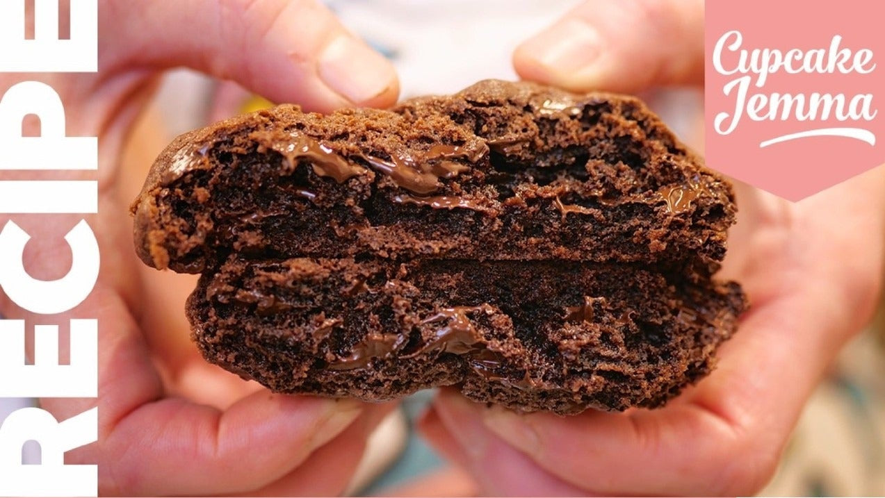 Close-up of a broken double chocolate cookie showing melted chocolate with Cupcake Jemma Double Chocolate New York Cookies recipe text