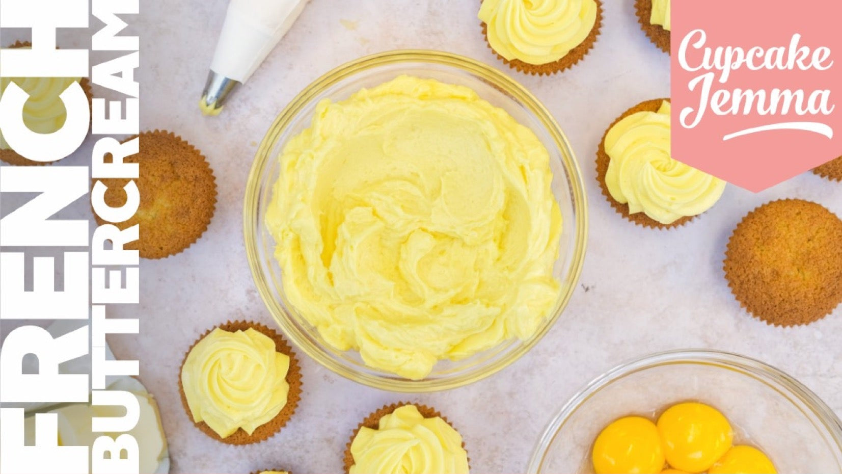 Bowl of smooth French Buttercream frosting with cupcakes, egg yolks, and ingredients for Cupcake Jemma recipe download.