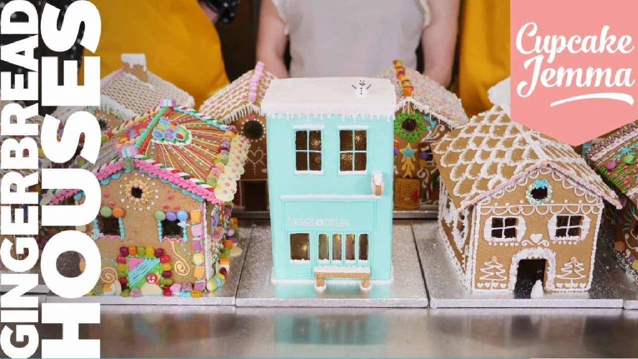 Decorated gingerbread houses lined up as examples for the Gingerbread House downloadable recipe downloadable recipe by Cupcake Jemma