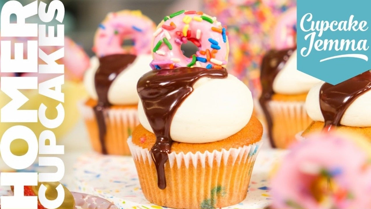 Close-up of a Homer Cupcakes downloadable recipe featuring vanilla cupcake with frosting, chocolate ganache, and mini donut topping