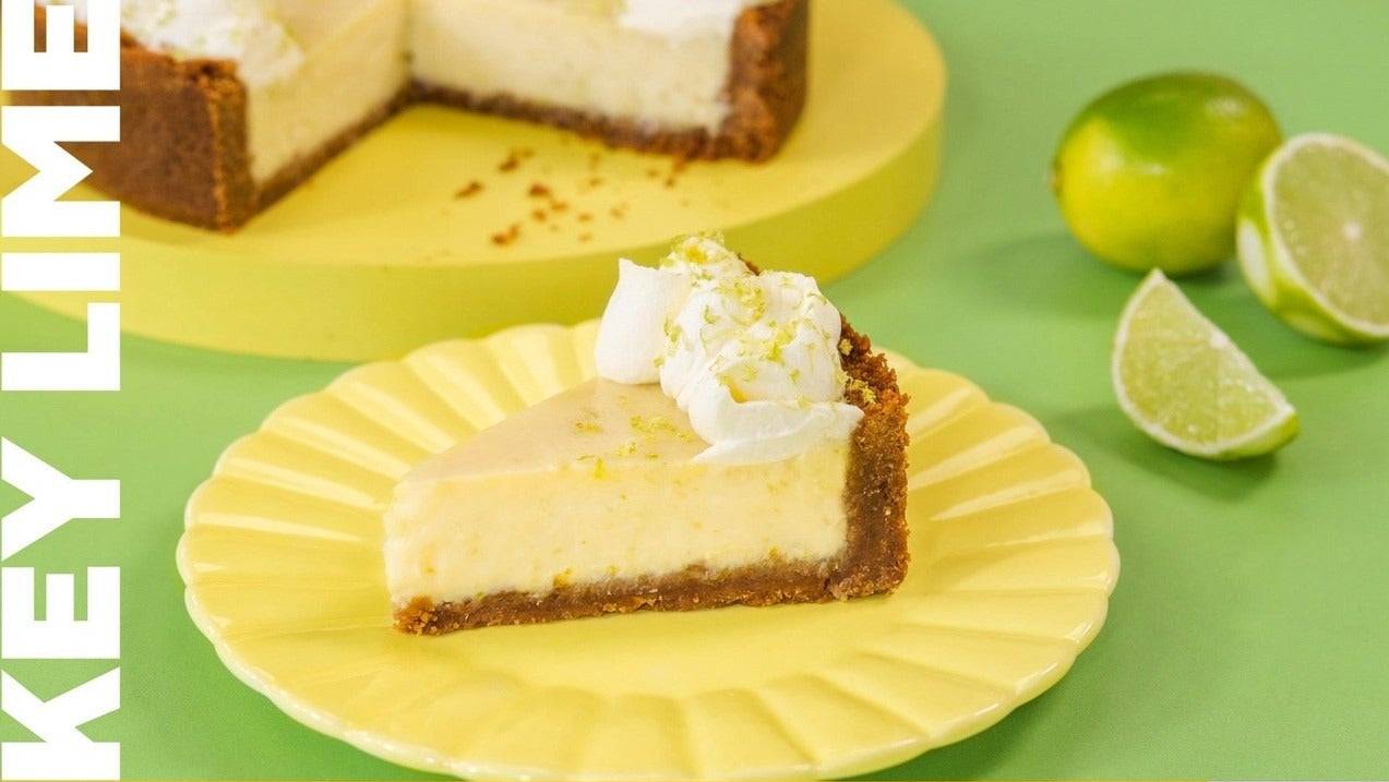 Slice of Key Lime Pie with whipped cream on yellow plate next to fresh limes and recipe ingredients text