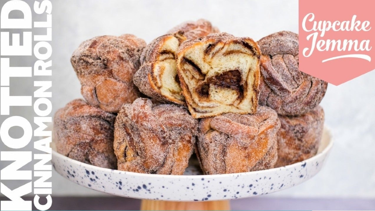 Knotted Cinnamon Rolls on a cake stand showcasing soft dough and cinnamon filling with sugar coating by Cupcake Jemma recipe