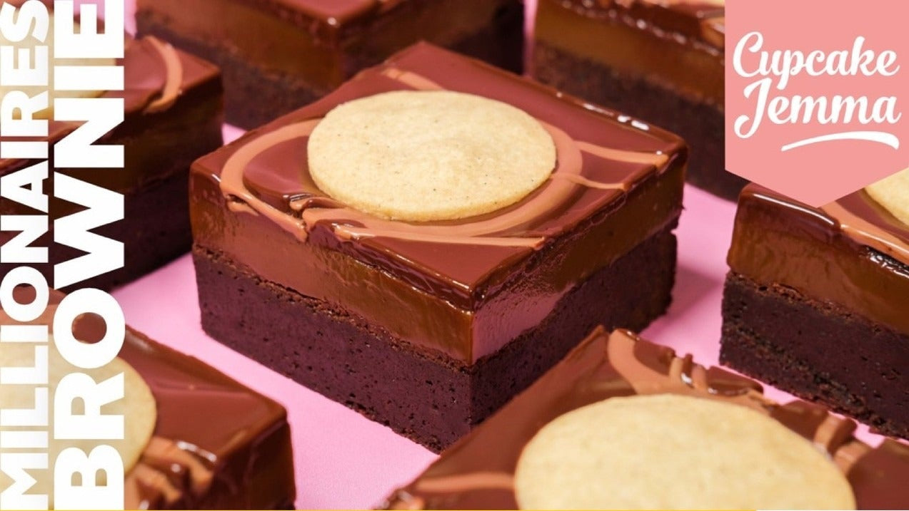 Close-up of rich Millionaires Brownie with layers of brownie, chocolate ganache, and shortbread cookie by Cupcake Jemma.