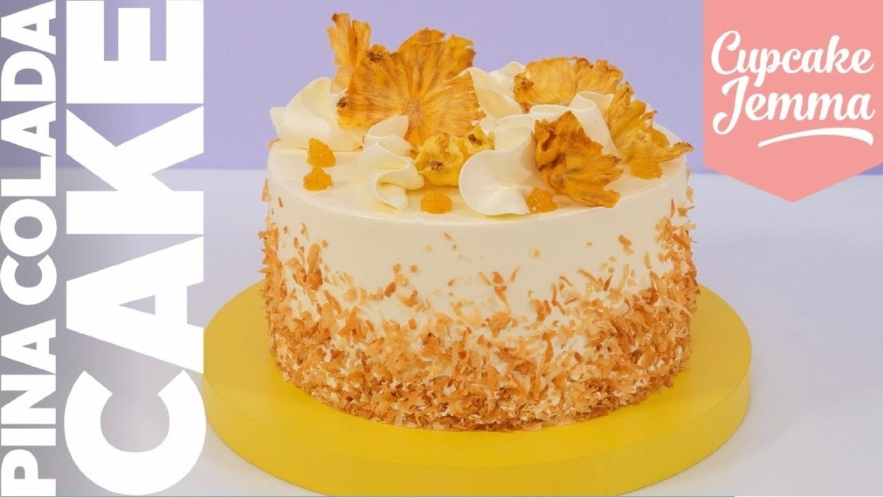 Pina Colada Cake with coconut frosting and dried pineapple flowers by Cupcake Jemma recipe download image