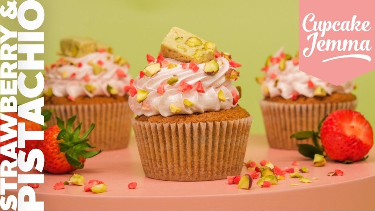 Pistachio and strawberry cupcakes with frosting and chopped pistachios, showcasing Cupcake Jemma’s downloadable recipe.