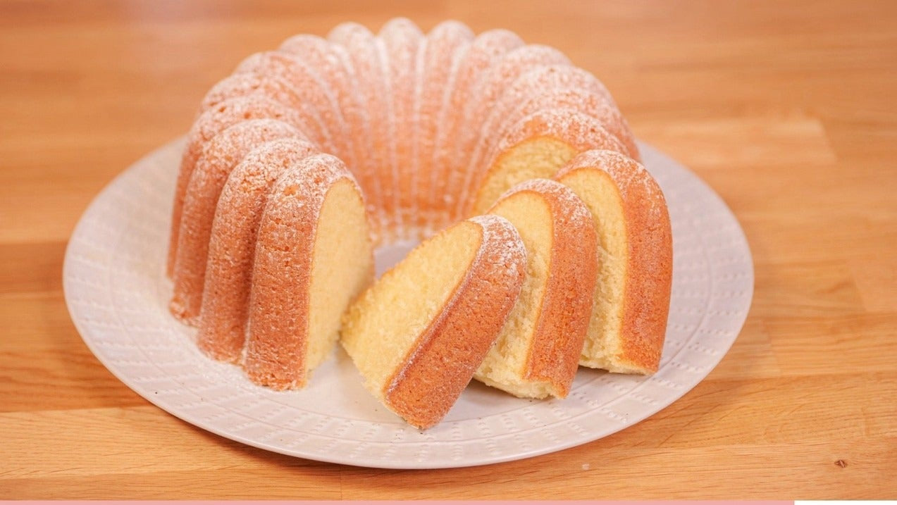 Slices of moist pound cake on a plate with a list of ingredients for the Pound Cake downloadable recipe below.