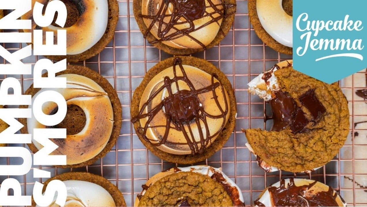 Close-up of pumpkin s’mores cookies with melted chocolate and toasted Italian meringue on a wire cooling rack for a downloadable recipe by Cupcake Jemma