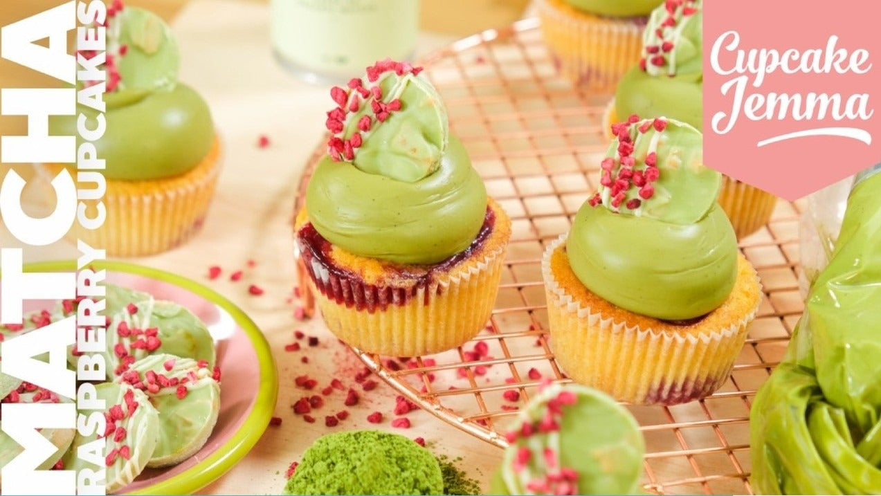 Close-up of Raspberry and Matcha Cupcakes with green frosting and red sprinkles on a cooling rack for a baking recipe by Cupcake Jemma