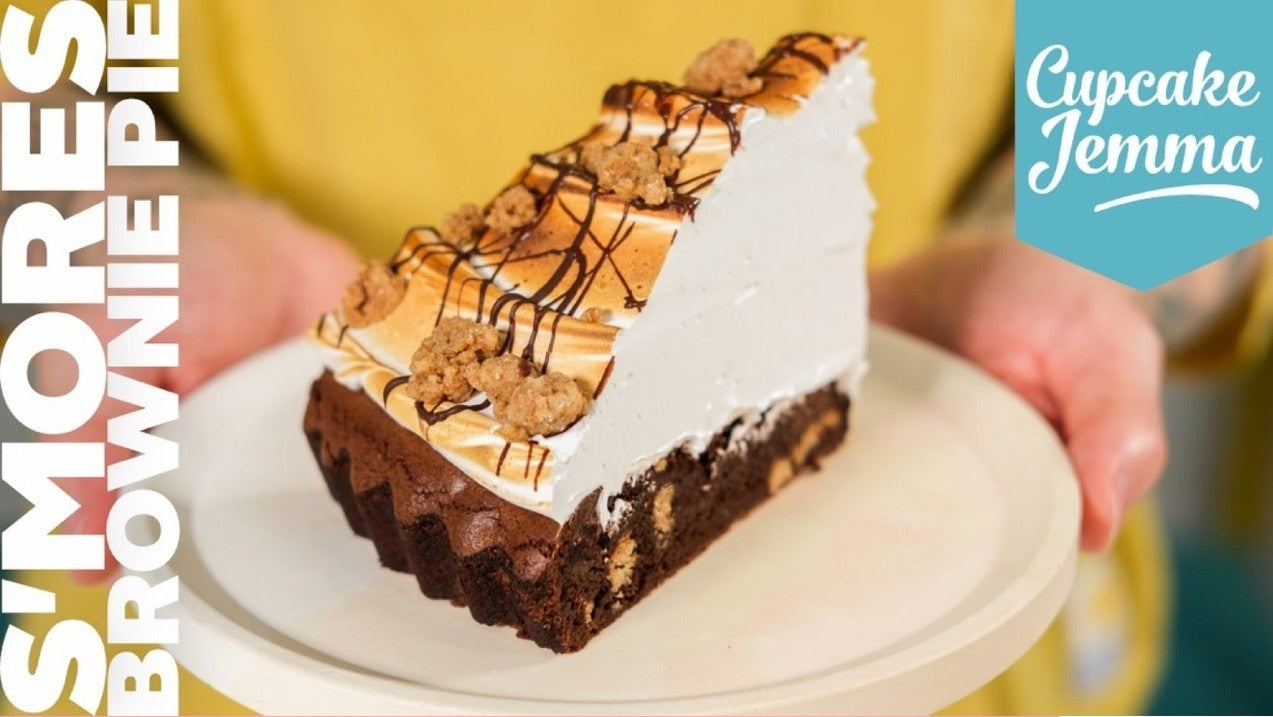Slice of s'mores brownie pie with toasted meringue topping on a plate from Cupcake Jemma baking recipe