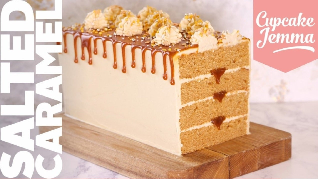Slice of salted caramel cake with dripping caramel and buttercream topping on wooden board recipe card