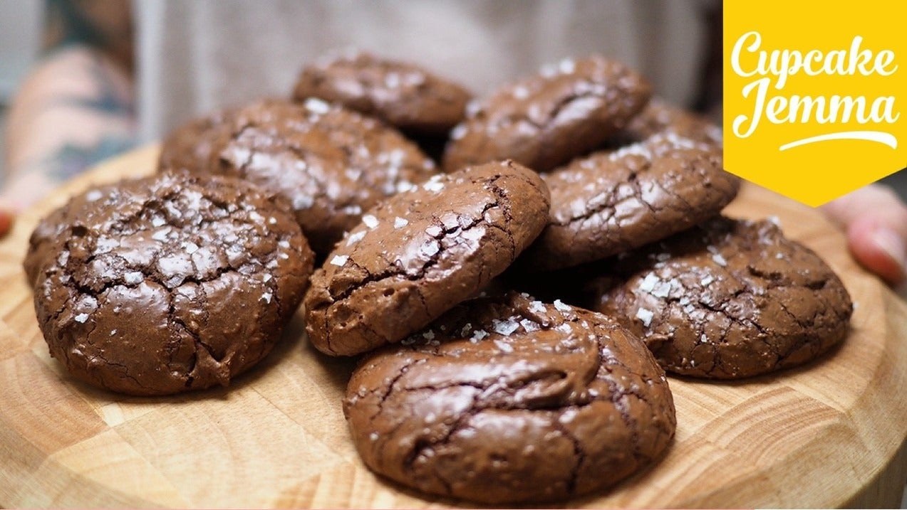 Close-up of salted chocolate brownie cookies on wooden board with recipe ingredients for baking Cupcake Jemma treat