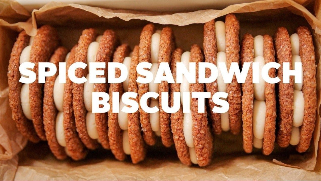 Rows of spiced sandwich biscuits with creamy filling and ingredient list for the downloadable recipe.