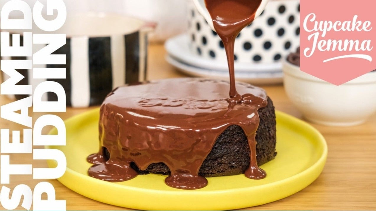 Steamed Chocolate Pudding with rich chocolate sauce pouring over moist cake on a yellow plate by Cupcake Jemma