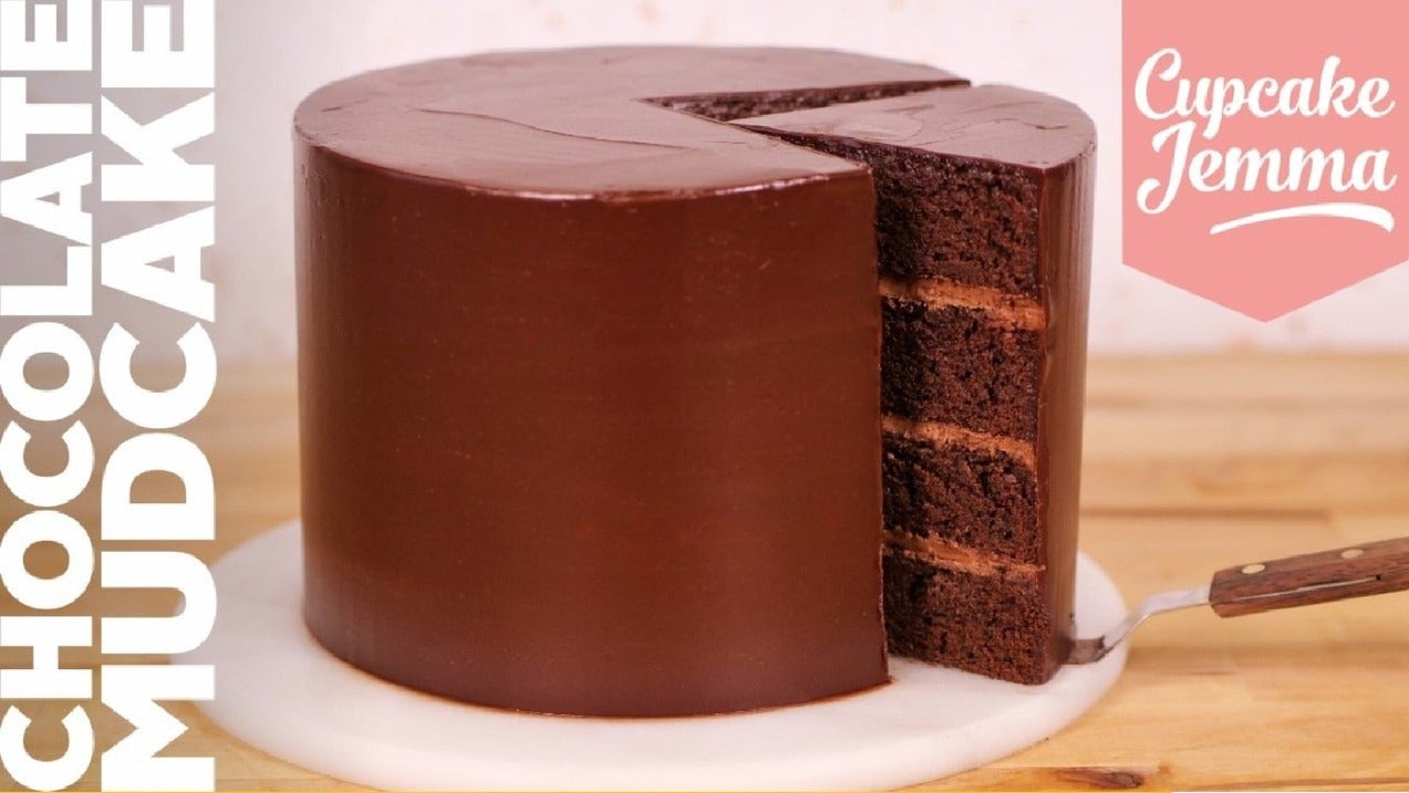 Rich chocolate mudcake with glossy ganache and layered sponge, Ultimate Chocolate Cake downloadable recipe by Cupcake Jemma.