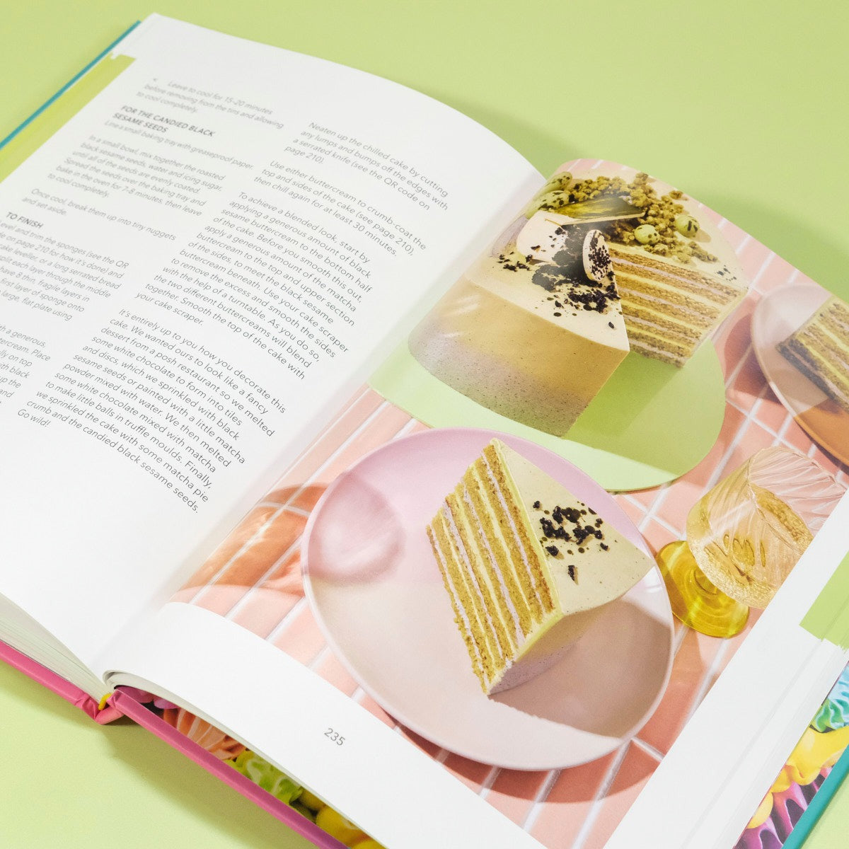 The Crumbs & Doilies Recipe Book open to a cake recipe page with layered cake images and detailed instructions.