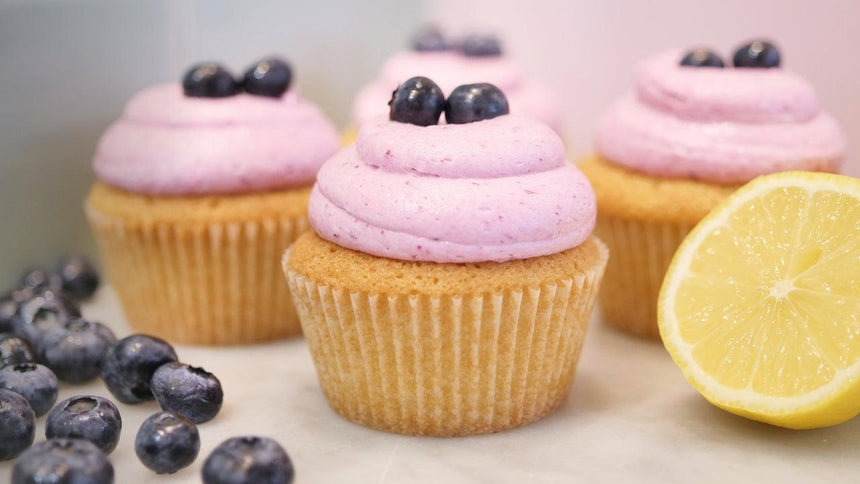 Curd-filled Lemon Cupcakes with Blueberry Buttercream Frosting